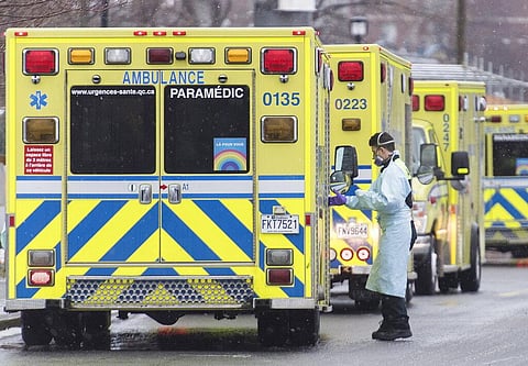 A paramedic is shown next to an ambulance outside a hospital in Montreal, Monday, Dec. 28, 2020, as the COVID-19 pandemic continues in Canada and around the world. (Photo | AP)