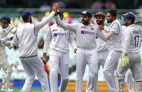 Indian players celebrate the dismissal of Australia's David Warner. (Photo | AP)