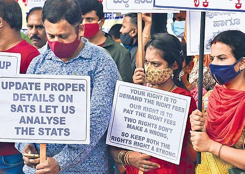 Parents stage a protest in Bengaluru on Sunday demanding that Education Minister S Suresh Kumar regulate school fees of privatye schools. (Photo | Shriram BN, EPS)