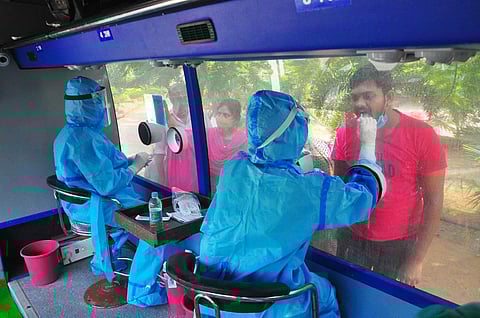 People give their swab samples for Covid-19 test at Sanjeevini bus at ENT Hospital in Visakhapatnam on Saturday. (Photo | G Satyanarayana, EPS)