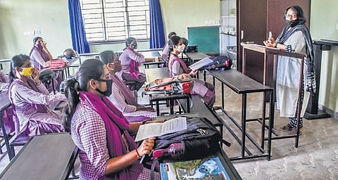 They maintain safe distance inside classroom at Kamala Nehru College in Bhubaneswar on Monday | Express