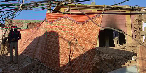 A police officer stand guard in a Hindu temple which was demolished by a mob led by Islamists, in Pakistan's Karak. (File photo| AP)