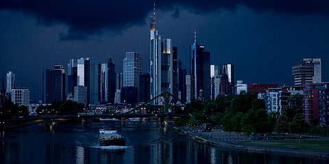 A cargo ship passes on the river Main with the buildings of the banking district in background in Frankfurt. (File photo| AP)