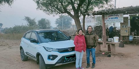 Aakash and his wife Kaushal in front of the electric vehicle they drove in. (Photo | Special arrangement)