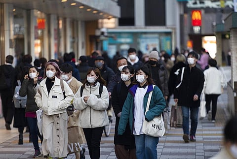 People wearing face masks walk by a train station during a coronavirus state of emergency in Tokyo on Thursday, Jan. 14, 2021. (Photo | AP)