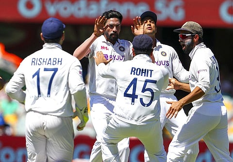 India's Mohammed Siraj, second left, celebrates with teammates after dismissing Australia's David Warner. (Photo | AP)