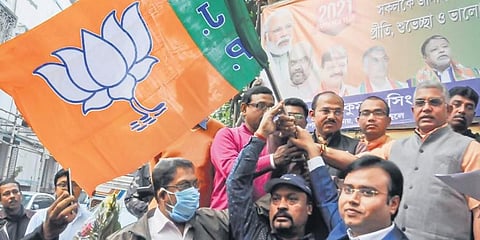 West Bengal BJP president Dilip Ghosh (R) hands over the party flag to a group of lawyers after they joined the saffron party in Kolkata on Saturday. (Photo | PTI)
