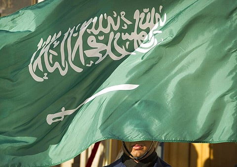 In this March 22, 2018, file photo, an honor guard member is covered by the flag of Saudi Arabia, in Washington. (Photo | AP)
