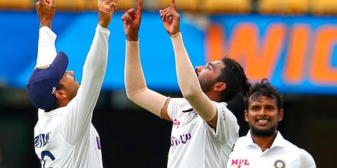 India's Mohammed Siraj (C) celebrates with teammate Mayank Agarwal (L) after taking his fifth wicket at Brisbane. (Photo | AP)
