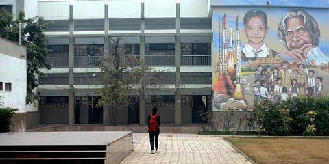 A student arrives at a Delhi government school after schools reopen for class 10th and 12th post the pandemic lockdown on Monday. (Photo | Shekhar Yadav, EPS)