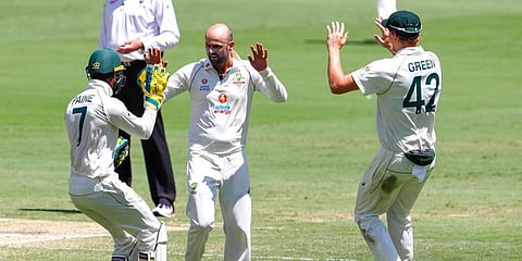 Australia's Nathan Lyon is congratulated by teammates after taking the wicket of India's Shubman Gill. (Photo | AP)
