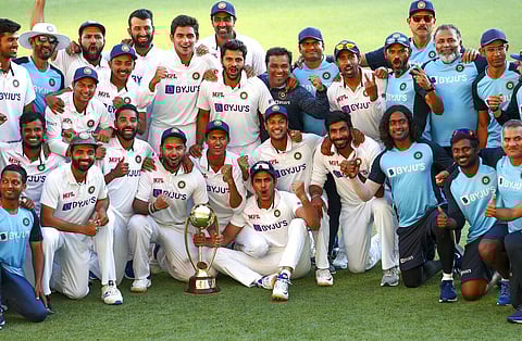 Indian players celebrate with their trophy after defeating Australia by three wickets. (Photo | AP)