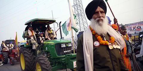 Farmers ride tractors during a protest against new farm laws at Ghazipur Border, in New Delhi. (Photo| ANI)