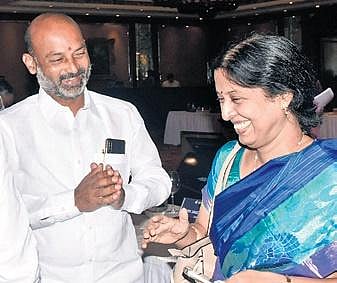 Bandi Sanjay shares a lighter moment with bureaucrat Y Srilakshmi at the Parliamentary Standing Committee Meeting in Hyderabad. (Photo | Express)
