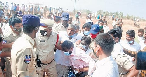 Police arrest farmers protesting against the environmental clearance given to NIMZ, during the public hearing on the issue, at Bardipur. (Photo | Express)