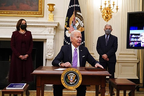US President Joe Biden responds to a reporters question after signing executive orders in the State Dinning Room of the White House, Thursday, Jan. 21, 2021, in Washington DC (Photo | AP)