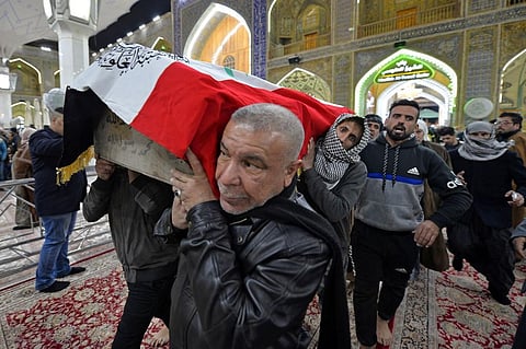 Iraqi mourners carry the coffin of a victim who was killed in a twin suicide bombing in central Baghdad. (Photo | AFP)
