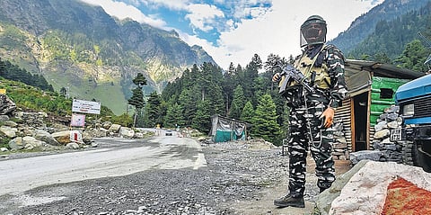 A security personnel stands guard along the Srinagar-Ladakh highway in Ganderbal district, central Kashmir. (File Photo | PTI)
