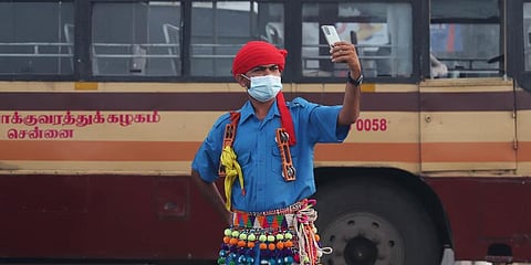 A maksed man takes a selfie during a full dress rehearsal ahead of Republic Day in Chennai. (Photo | Sri Loganathan, EPS)
