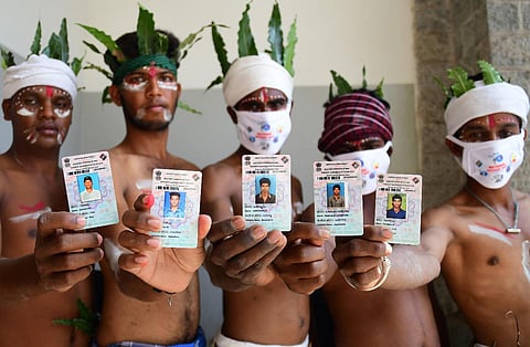 First time voters from soliga tribal community from hanur taluk in Chamarajanagar showing their Voter ID card on the occasion of national voters day in Bengaluru. (Photo | Shriram BN, EPS)