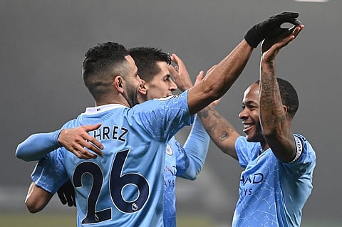 Manchester City's English midfielder Raheem Sterling (R) celebrates scoring his team's fifth goal with teammates. (Photo | AFP)