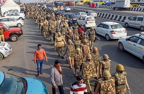 Security personnel conduct a flag march at Ghazipur border during the ongoing farmers' agitation against Centre's farm reform laws, in New Delhi. (Photo | PTI)