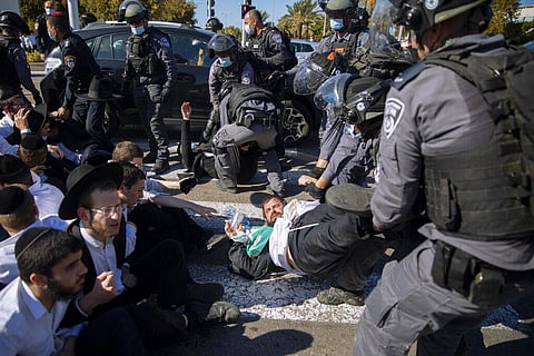Israeli police officers clash with ultra-Orthodox Jews during a protest over the coronavirus lockdown restrictions, in Ashdod, Israel, Sunday. (Photo | AP)