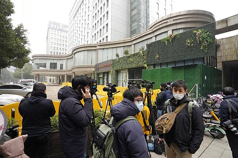 Journalists gather outside the hotel where a team of experts from the World Health Organization are quarantined in Wuhan in central China's Hubei province on Thursday. (Photo | AP)