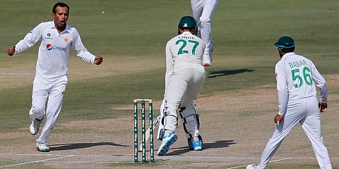 Pakistan's spinner Nauman Ali (L) celebrates after taking the wicket of South Africa's George Linde (27) during the fourth day of the first Test match at the National Stadium, in Karachi. (Photo | AP)