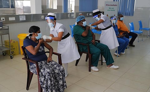Sri Lankan nursing staff administer COVID-19 vaccines to frontline health workers in Colombo. (Photo | AP)