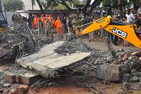 Rescue operation carried out by NDRF personnel after the complex roof of a crematorium collapsed due to heavy rain. (Photo | PTI)