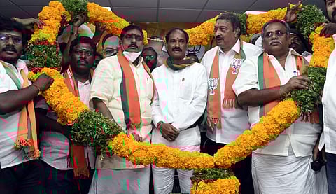 Former Puducherry minister A Namasivayam and Ex-MLA E Theepianthan welcomed in the BJP party office with a garland. (Photo | Express)