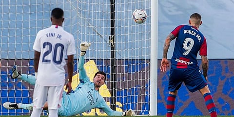 Real Madrid's goalkeeper Thibaut Courtois, background, stops a penalty kick by Levante's Roger Marti. (Photo | AP)