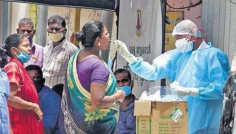 A health staff taking swab sample from a woman for testing at a camp set up in Madurai. (Photo | KK Sundar, EPS)