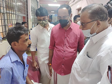 Udma MLA K Kunhiraman and BJP district president K Shreekanth speaking with Narayana Naik, who lost his son in the accident. (Photo | Express)