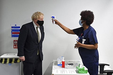 Britain's Prime Minister Boris Johnson has his temperature checked during a visit to Chase Farm Hospital in north London. (Photo | AP)