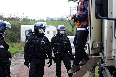 A man exits a vehicle after being checked by gendarmes, near Lieuron, Brittany, France, Saturday, Jan. 2, 2021. (Photo | AP)