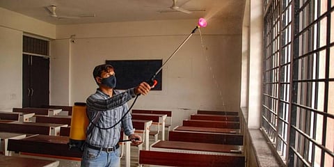 A worker sanitises a classroom. (Photo | PTI)