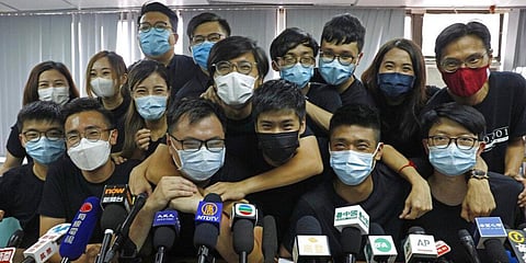 Pro-democracy activists who were elected from unofficial pro-democracy primaries, including Joshua Wong (L) attend a press conference. (File photo| AP)