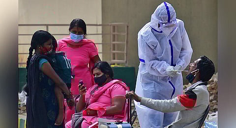 A health worker collects samples at Majestic bus stand in Bengaluru. (Photo I Shriram BN, EPS)