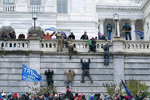 Supporters of President Donald Trump climb the west wall of the the U.S. Capitol on Wednesday, Jan. 6, 2021, in Washington. | AP