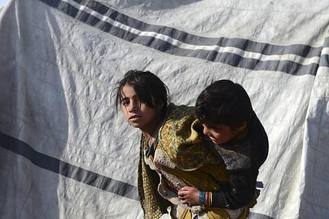 Children play next to a tent at a camp for internally displaced families in Dand district of Kandahar province. (Photo | AFP)
