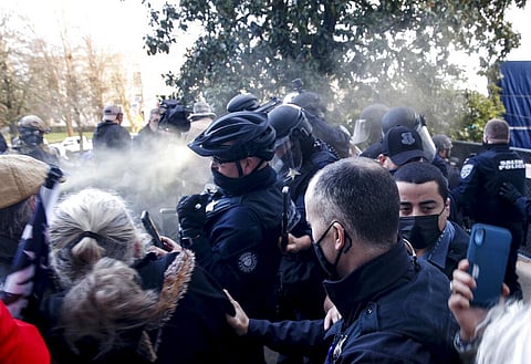 In this Dec. 21, 2020, file photo, protesters spray mace toward police as they attempt to get into the Oregon State Capitol. (Photo | AP)