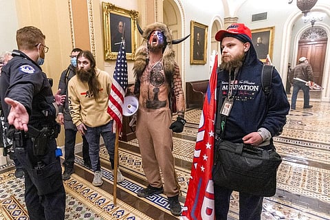 Supporters of President Donald Trump are confronted by Capitol Police officers outside the Senate Chamber inside the Capitol. (Photo| AP)