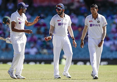 Ravichandran Ashwin, left, Jasprit Bumrah and Navdeep Saini, right, seen talking during play on day three of the Sydney Test. (Photo | AP)