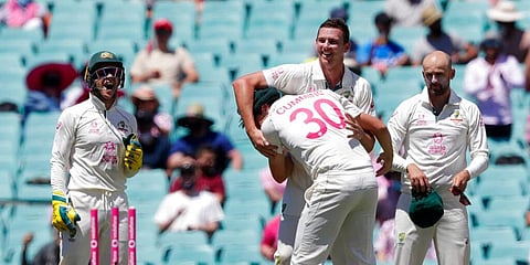 Australia's Josh Hazlewood, centre, is congratulated by teammate Patrick Cummins after running out India's Hanuma Vihari. (Photo | AP)