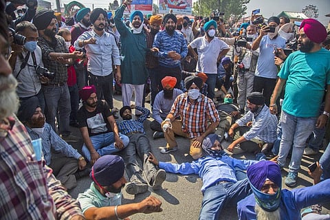 Sikh community members shout slogans as they block the road during the funeral procession of Satinder Kaur in Srinagar. (Photo | AP)