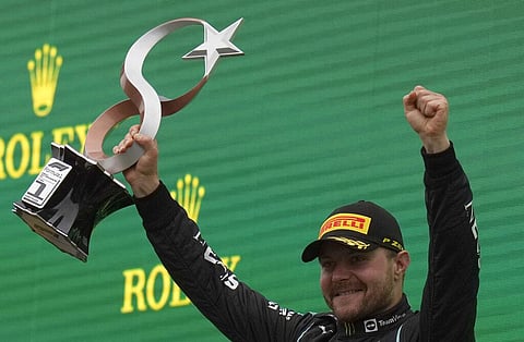 Mercedes driver Valtteri Bottas holds trophy on podium after winning the Turkish Formula One Grand Prix at Intercity Istanbul Park circuit in Istanbul, Turkey, Sunday. (Photo | AP)