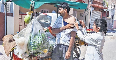 A vegetable vendor at Bikaner in Rajasthan gets inoculated on Saturday. (Photo | PTI)