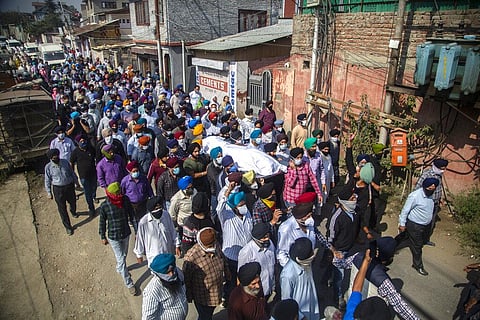 In this Oct. 8, 2021 file photo, Sikh community members carry the body of slain Satinder Kaur, a government school teacher during her funeral procession in Srinagar. (Photo | AP)